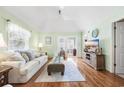 Bright living room with light green walls, hardwood floors, light-colored furniture, and lots of natural light at 820 9Th Ave. S, North Myrtle Beach, SC 29582