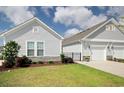 Single-story home featuring stone accents, manicured lawn, and a two-car garage at 830 San Marco Ct. # 2603-B, Myrtle Beach, SC 29579