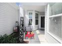 Cozy front porch with decorative welcome sign, rocking chair, and charming decor at 830 San Marco Ct. # 2603-B, Myrtle Beach, SC 29579
