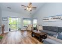 Bright living room boasts wood floors, vaulted ceilings, and access to a balcony at 100 Birch N Coppice Dr. # 12, Surfside Beach, SC 29575