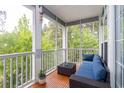 Relaxing screened-in patio offers comfortable seating and views of lush greenery at 100 Birch N Coppice Dr. # 12, Surfside Beach, SC 29575