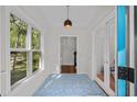 Bright entryway with decorative tiled flooring, complemented by large windows overlooking the lush greenery of the front yard at 1029 Old Plantation Dr., Pawleys Island, SC 29585