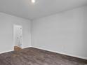 Spacious bedroom featuring sleek, dark hardwood floors, white walls, and ample natural light at 1055 Sentinel Ct., Little River, SC 29566