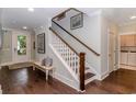 Bright foyer features hardwood floors, bench seating, decorative rug, stairs and white trim at 1079 Milford Way, Myrtle Beach, SC 29588