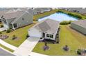 Aerial view of a well maintained house with a pond in the backyard, showing the landscape of the neighborhood at 1135 Sennema Circle, Myrtle Beach, SC 29588