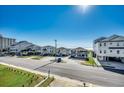 Street view of houses, with some elevated on stilts, with view of ocean in the background at 1208 S Ocean Blvd. # H, North Myrtle Beach, SC 29582