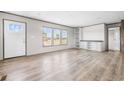 Inviting living room with wood-look flooring, white walls, natural light, and built-in shelving for added storage at 121 Forman Way, Aynor, SC 29511