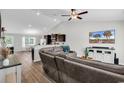 Well-lit living room with vaulted ceiling and a view into the breakfast area and kitchen at 122 Desurrency Ct., Georgetown, SC 29440