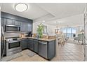 Open kitchen featuring gray cabinets, stainless steel appliances, granite countertops, and an ocean view at 1401 S Ocean Blvd. # 506, North Myrtle Beach, SC 29582