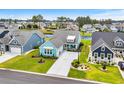 Beautiful home with a well-kept lawn and landscaping in a waterfront community with lake views at 143 Starlit Way, Myrtle Beach, SC 29579