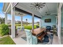 Covered patio with multiple ceiling fans, a view of the yard and lake at 143 Starlit Way, Myrtle Beach, SC 29579