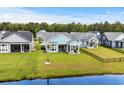 Beautiful home with a well-kept lawn and landscaping in a waterfront community with lake views at 143 Starlit Way, Myrtle Beach, SC 29579