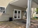 Back patio featuring double doors, a ceiling fan, and a partially fenced in yard at 1440 Brighton Ave., Myrtle Beach, SC 29588