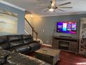 Cozy living room with hardwood floors, a stone fireplace, a ceiling fan and a TV at 1440 Brighton Ave., Myrtle Beach, SC 29588
