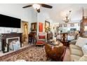 Spacious living room with a fireplace, large area rug, and an open floor plan leading to the dining area and kitchen at 146 Stillwood Dr. # 3, Pawleys Island, SC 29585