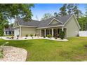 Manicured front yard with green lawn, shrubs, and stone accents at 1610 Old Tram Rd., Little River, SC 29566