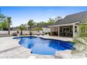 Backyard pool surrounded by palm trees and patio furniture at 1610 Old Tram Rd., Little River, SC 29566