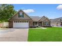 Beautiful single-story home with well-kept lawn, attached garage, and inviting front porch at 1674 Sw Beach Dr., Calabash, SC 28467