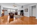 Bright living room featuring hardwood floors, a vaulted ceiling, and large windows for natural light at 1701 Boyne Dr., Myrtle Beach, SC 29588
