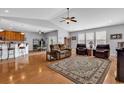 Open-concept living room with hardwood floors, ceiling fan, and seamless flow into the kitchen and dining area at 1701 Boyne Dr., Myrtle Beach, SC 29588