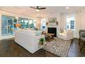 Bright, open living room with fireplace, large windows, and hardwood floors, perfect for relaxation and entertaining at 1804 Tryon Dr, Myrtle Beach, SC 29588