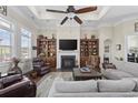 Bright living room with a fireplace, built-in shelving, and comfortable seating, perfect for relaxation at 200 Stonefly Ct., Murrells Inlet, SC 29576