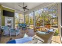 Relaxing screened porch with comfortable seating, ceiling fan, and views of the serene backyard at 200 Stonefly Ct., Murrells Inlet, SC 29576