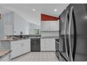 Bright kitchen showcasing granite countertops, white cabinets, and black appliances at 206 Pipers Ln. # 206, Myrtle Beach, SC 29575