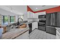 Charming kitchen features granite countertops, white cabinets, and black appliances at 206 Pipers Ln. # 206, Myrtle Beach, SC 29575