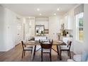 Open floor plan showcases a dining area leading into a kitchen with white cabinets and stainless steel appliances at 2107 Victory Way # 496, Myrtle Beach, SC 29579