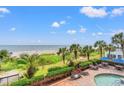 Breathtaking beach view from the condo showing palm trees, lush vegetation, and people enjoying the ocean at 2401 S Ocean Blvd. S # 267, Myrtle Beach, SC 29577