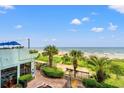 Beautiful beach view from the condo, with a path to the sand and palm trees at 2401 S Ocean Blvd. S # 267, Myrtle Beach, SC 29577