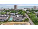 Aerial view of condo building with a coastal cityscape in the background at 250 Maison Dr. # J-11, Myrtle Beach, SC 29572