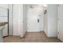 Hallway includes laundry closet, tile floors, and utility closet at 2506 North Ocean Blvd. # 534, Myrtle Beach, SC 29577