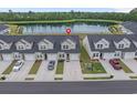 Aerial view of townhomes with a tranquil pond, set amongst lush green trees at 291 Brackish Dr. # 291, Myrtle Beach, SC 29588