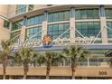 A vista of Avista Resort entrance with swaying palm trees in front of the building at 300 N Ocean Blvd. # 1732, North Myrtle Beach, SC 29582