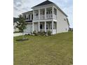 Charming two-story home with double porch and green lawn, offering great curb appeal at 3019 Visionary Dr., Myrtle Beach, SC 29588