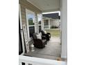 Relaxing front porch featuring wicker chairs, throw pillows, and a welcoming decor at 3019 Visionary Dr., Myrtle Beach, SC 29588