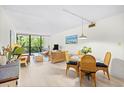 Bright living and dining area with wicker furniture, light wood floors and sliding glass doors to a balcony at 311 71St Ave. N # 3-D, Myrtle Beach, SC 29572