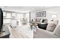 Inviting living room open to dining with neutral palette, modern furnishings, and lots of light at 3208 Nw Edgemead Circle # B, Calabash, NC 28467