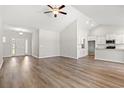 Open-concept living room with wood-look flooring, high ceilings, and abundant natural light at 3331 Little Bay Dr., Conway, SC 29526
