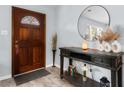 Inviting entryway with a decorative door, stylish console table, and a round mirror that enhances the bright space at 4 Catawba Ct., Myrtle Beach, SC 29588