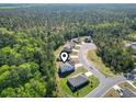 An aerial shot shows the property's location within a community surrounded by a lush, green forest at 4005 Sweetspire Court, Conway, SC 29526