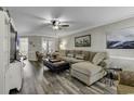 Bright living room with hardwood floors, neutral paint, ceiling fan and large comfortable couch at 407 15Th Ave. S, North Myrtle Beach, SC 29582
