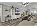 Bright living room with hardwood floors, neutral paint, ceiling fan and open concept access to kitchen at 407 15Th Ave. S, North Myrtle Beach, SC 29582