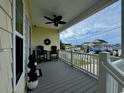 Inviting covered porch with seating offering neighborhood views with a decorative ceiling fan at 412 29Th Ave. N, North Myrtle Beach, SC 29582