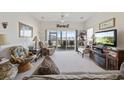 Bright and airy living room with comfortable seating and access to the screened patio at 4200 Coquina Harbour Dr. # H5, Little River, SC 29566