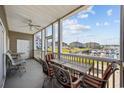 Relaxing screened patio with comfortable seating and a view of the marina at 4200 Coquina Harbour Dr. # H5, Little River, SC 29566