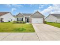 Traditional home with a two-car garage, a well-maintained lawn, and inviting curb appeal at 4200 Woodcliffe Dr., Conway, SC 29526