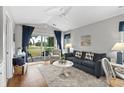 Cozy living room with a comfortable couch, ceiling fan and sliding door leading to the porch at 461 Red River Ct. # 36-I, Myrtle Beach, SC 29579